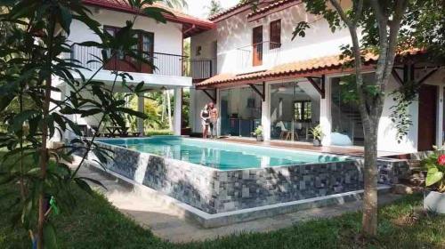 a swimming pool in the backyard of a house at Forest Avenue - Kurunegala in Torayaya