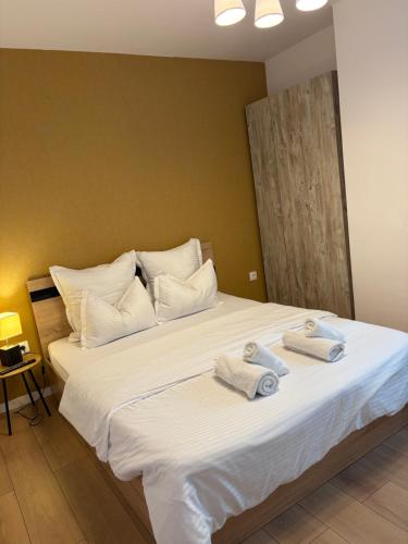 a bedroom with a large white bed with towels on it at Best View Terrace in Târgu-Mureş