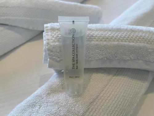 a bottle of sunscreen sitting on top of towels at Weezen by Gracht in Zwolle