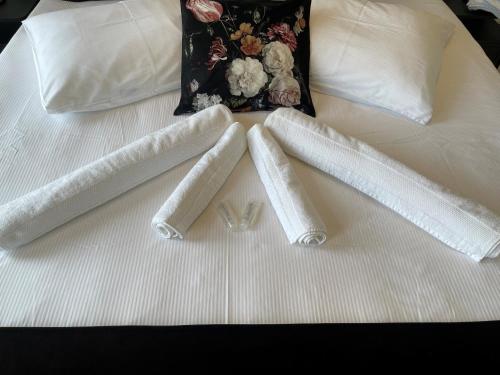 two white towels on top of a bed at Weezen by Gracht in Zwolle