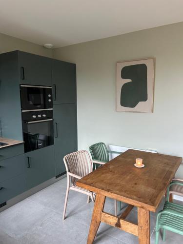a dining room with a wooden table and chairs at Refuge nature de Aumontzey in Granges-Aumontzey