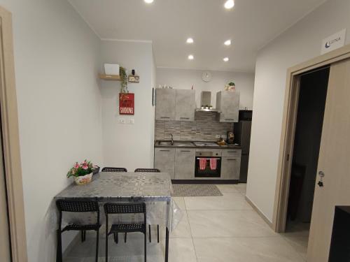 a kitchen with a table and chairs and a stove at La casa di Flò in Ercolano