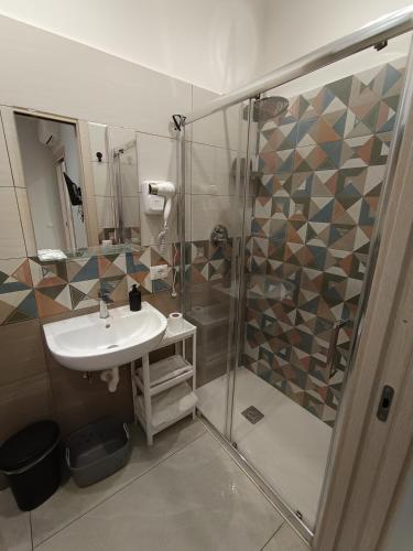 a bathroom with a sink and a shower at La casa di Flò in Ercolano