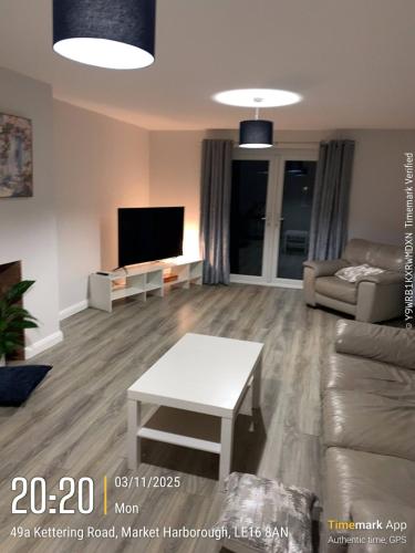 a living room with a couch and a table at Large 4 bedroom Family let, Contractor, Corporate in Market Harborough