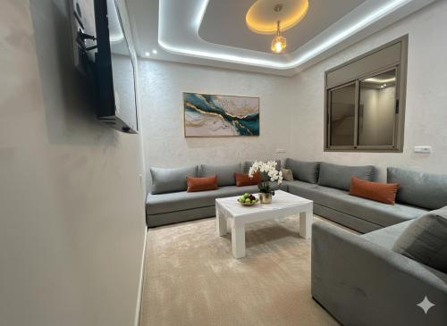 a living room with a couch and a table at Hotel America Apartments in Dakhla