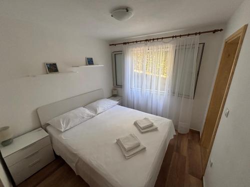 Ένα ή περισσότερα κρεβάτια σε δωμάτιο στο Apartments Gugic