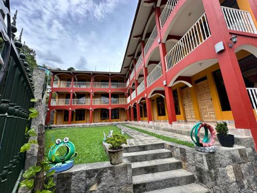 a courtyard of a building with stairs and plants at Hotel Adulam in San Pedro La Laguna