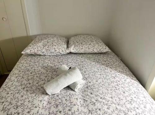 a bed with two rolls of toilet paper on it at Pilori 2 pers, separate bedroom, Tv wifi in Nantes