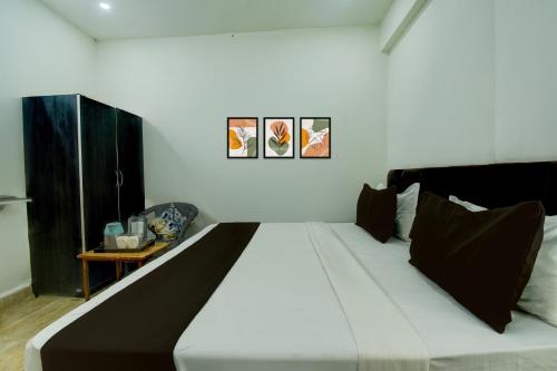 Ένα ή περισσότερα κρεβάτια σε δωμάτιο στο Hotel O H Pass