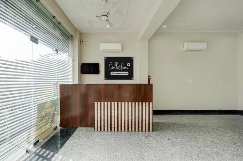 a lobby with a reception desk and a sign on the wall at Collection O Kesar Crossway Jaipur Formerly Laxmi Palace in Jaipur