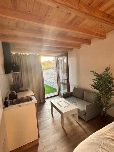 a kitchen and a living room with a couch and a table at La Herrería de Somo 1 in Somo