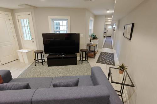 a living room with a couch and a flat screen tv at Explorers Paradise Walk to Capitol in Washington, D.C.