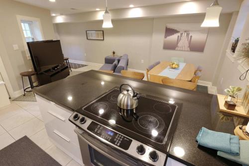 a kitchen with a stove and a living room at Explorers Paradise Walk to Capitol in Washington, D.C.