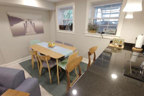 a kitchen and dining room with a table and chairs at Explorers Paradise Walk to Capitol in Washington, D.C.