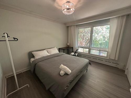 a bedroom with a bed with a stuffed animal on it at Modern Private Room with Bessarion Subway North York in Toronto