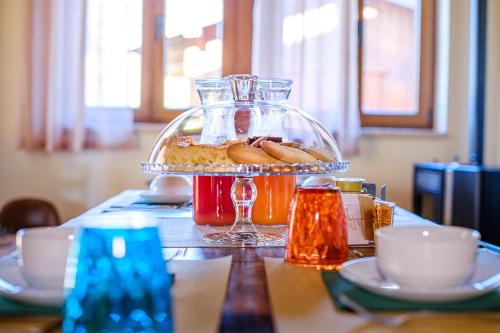 a table with a plate of food on a table at Dolcevita guest house in Torreano