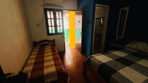 Ein Bett oder Betten in einem Zimmer der Unterkunft Pousada 100 passos