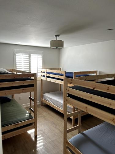 a room with three bunk beds and a window at Normandie Good Vibes Only in Los Angeles