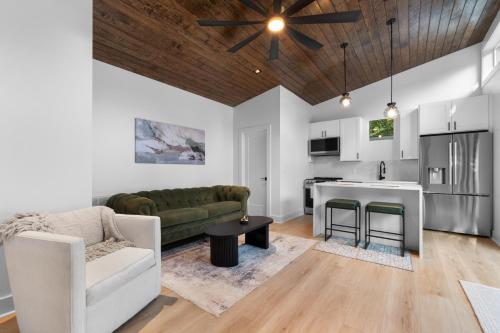 a living room with a couch and a kitchen at The Raven A Luxury Guest House in Charlotte