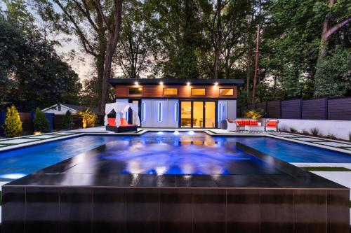 a house with a swimming pool in the backyard at The Raven A Luxury Guest House in Charlotte