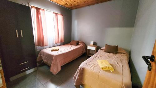 Ένα ή περισσότερα κρεβάτια σε δωμάτιο στο Hospedaje Rincón del Sur