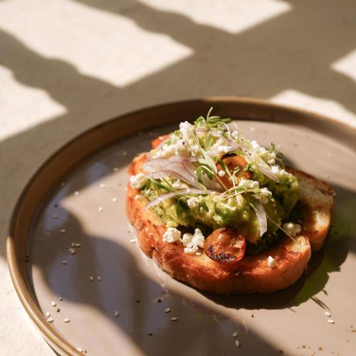 a piece of bread with guacamole on a plate at B Haus Hotel Boutique in Cartagena de Indias