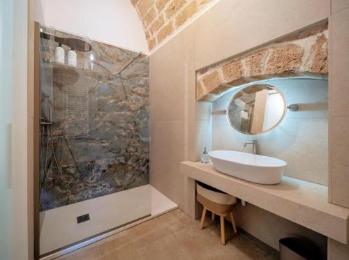 a bathroom with a sink and a mirror at SuiteLab in Palo del Colle