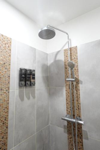 a bathroom with a shower with a glass door at Comfort Parisian Room and Sofa Bed 1 min to Metro M4 & T3A in Paris