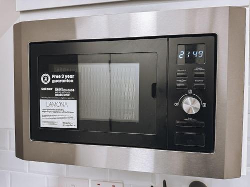 a microwave oven sitting on top of a wall at Charming Studio in the Heart of Ealing Broadway in Ealing