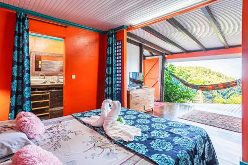 a bedroom with two pink swans on a bed at Villa douillette à Deshaies – Vue sur la mer et la montagne - 96 m² in Deshaies