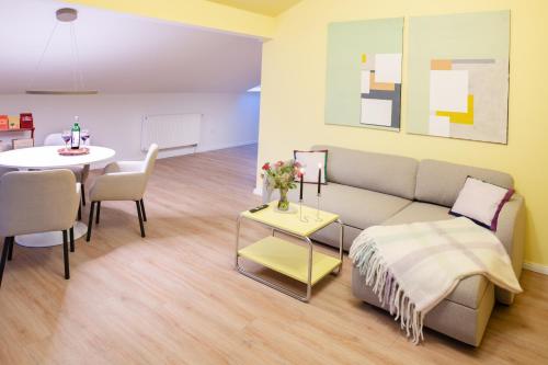 a living room with a couch and a table at Design-Apartment Worpswede in Worpswede
