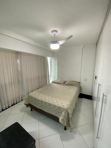 a bedroom with a bed and a ceiling fan at Próximo a praia das castanheiras, internet, cooler, cadeiras de praia,roupas de cama e banho in Guarapari