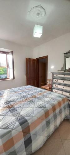 a bedroom with a large bed and a dresser at la buca delL'IStrice in Monteriggioni