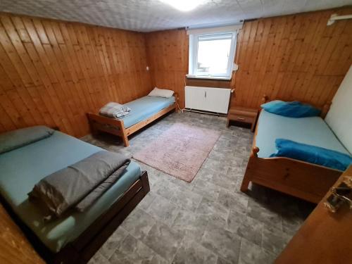 a room with two beds and a window at Ramstein Wohnung in Ramstein-Miesenbach