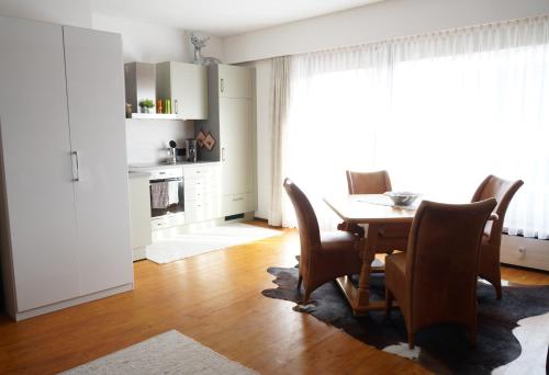 a dining room with a table and chairs at Wohlfühlstudio Bergblick in Walchsee in Walchsee