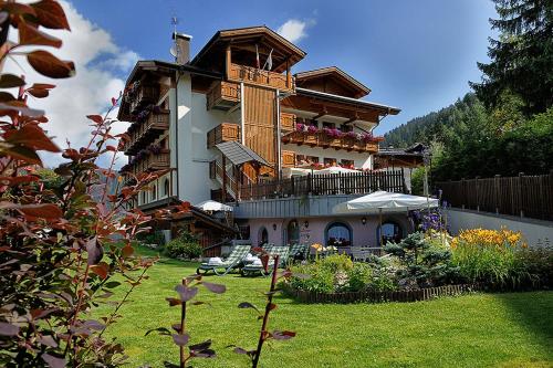 a large building with a yard in front of it at Hotel Gianna in Madonna di Campiglio