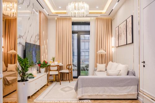 a bedroom with a bed and a dining room at Nest One Luxe, Элитные апартаменты с террасой и панорамным видом 067 in Tashkent