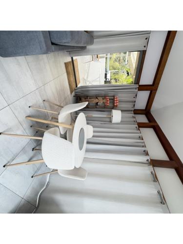 an overhead view of a staircase with two white chairs at Fully-equipped house with pool in Grande Saline