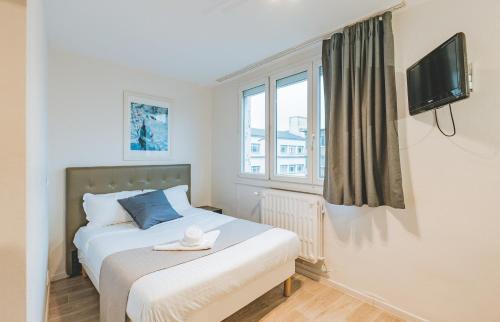 Ένα ή περισσότερα κρεβάτια σε δωμάτιο στο Le Faidherbe Hotel Coeur de ville