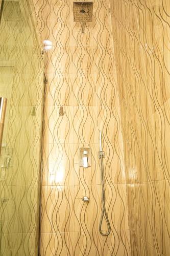 a bathroom with a shower with a toilet and a shower at The Peak Residence in Ibadan