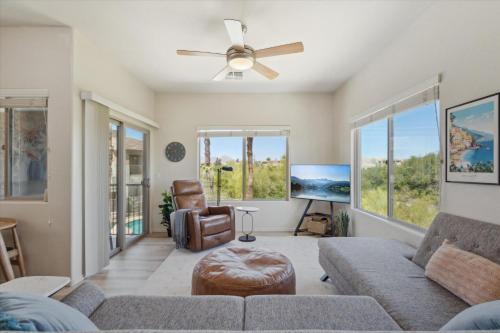 a living room with a couch and a ceiling fan at Panorama View - Mountain Views - Community Pool in Fountain Hills