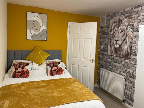 a bedroom with a bed and a painting of a lion at Spacious two bedroom flat, entire property in Greenock