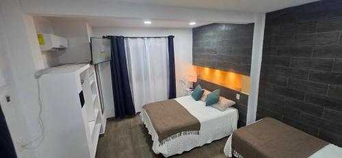 Postel nebo postele na pokoji v ubytování El Malecon, Central Mini Apartments