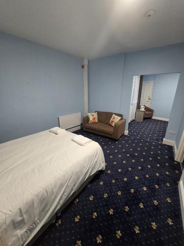 a bedroom with a bed and a couch in it at Maqs Bistro in Egremont