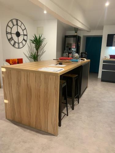 Appartement en hyper-centre في فيجيا: مطبخ يحتوي على جزيرة خشبية كبيرة في غرفة