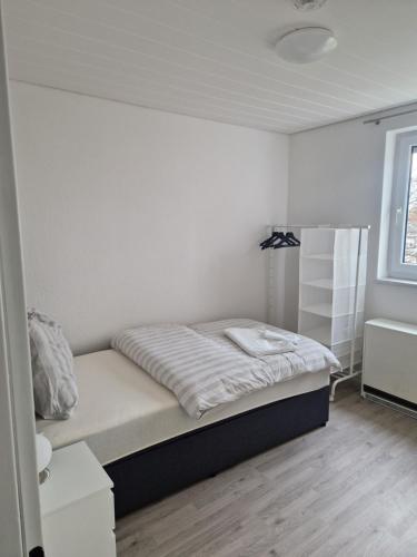 a small bedroom with a bed and a window at Ferienwohnung Biberach an der Riß in Biberach an der Riß