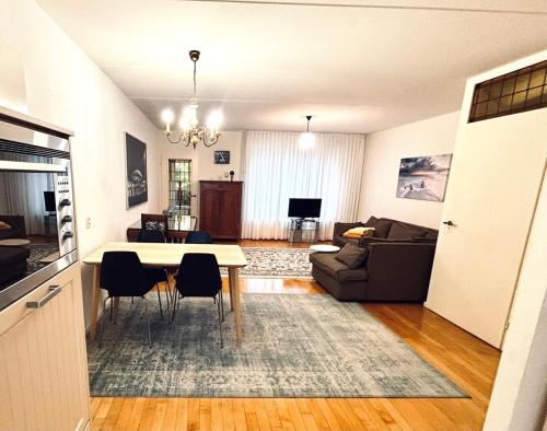 a kitchen and living room with a table and chairs at Entire home, 3 bedrooms garden Strijp within ring in Eindhoven