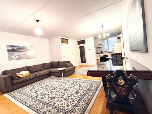 a living room with a couch and a table at Entire home, 3 bedrooms garden Strijp within ring in Eindhoven