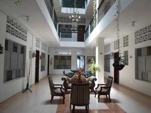 a large room with chairs and a table in it at Gran Hotel El Cedro in Girardot