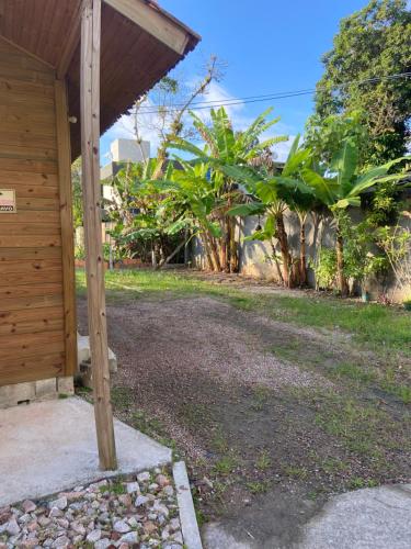 a porch of a house with a gravel driveway at Bombinhas, Casa mobiliada 1 quarto in Bombinhas